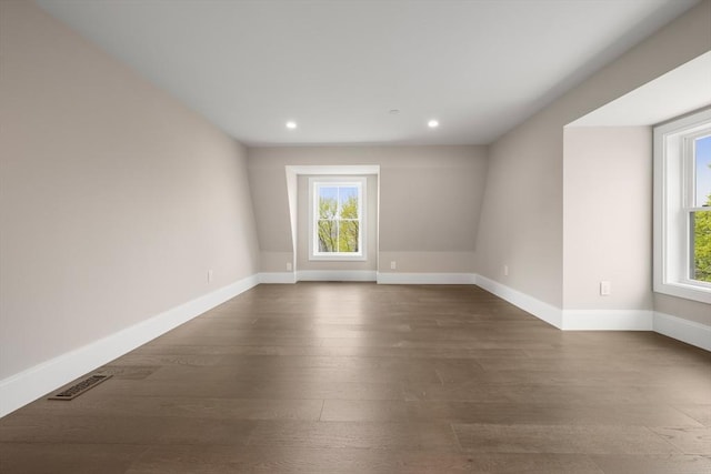spare room featuring recessed lighting, baseboards, visible vents, and dark wood-type flooring