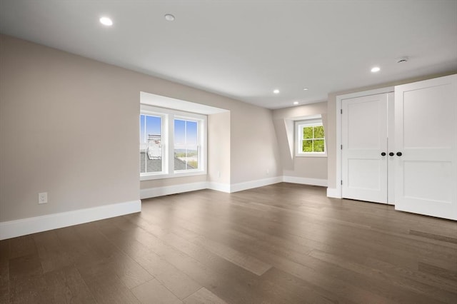 unfurnished room featuring baseboards, recessed lighting, and dark wood-type flooring