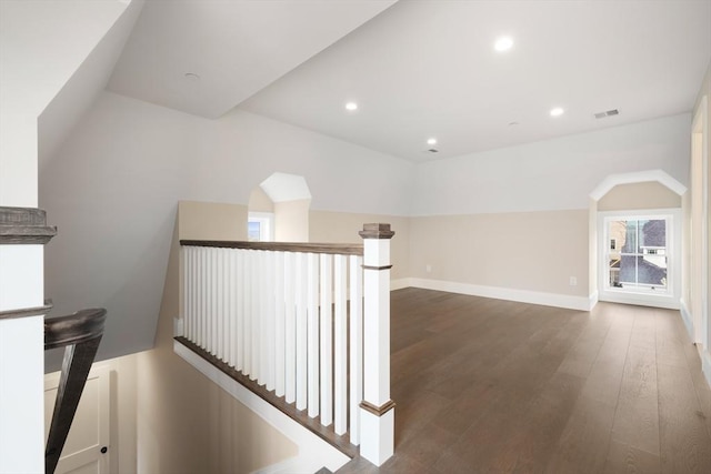 hall featuring visible vents, baseboards, recessed lighting, dark wood finished floors, and an upstairs landing