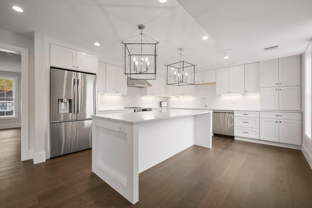 kitchen featuring an inviting chandelier, a center island, white cabinets, and stainless steel appliances
