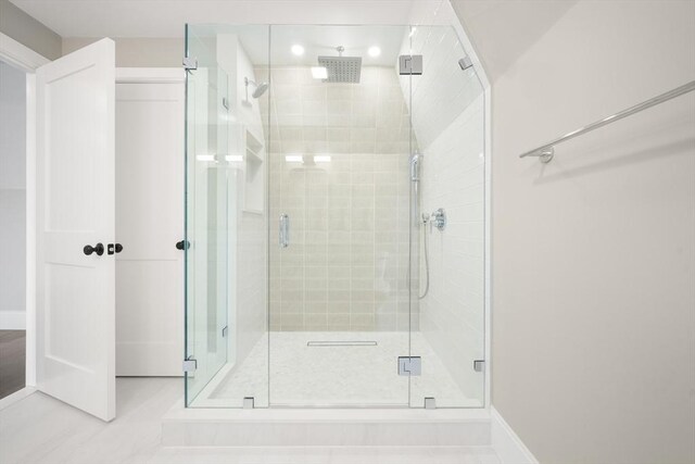 full bathroom featuring baseboards and a stall shower