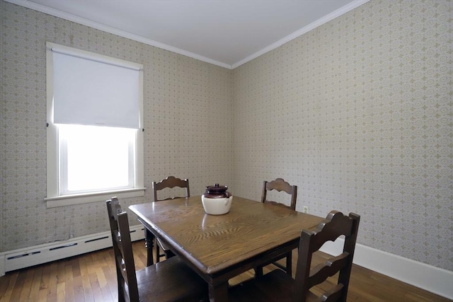 dining area featuring crown molding, dark hardwood / wood-style flooring, and baseboard heating