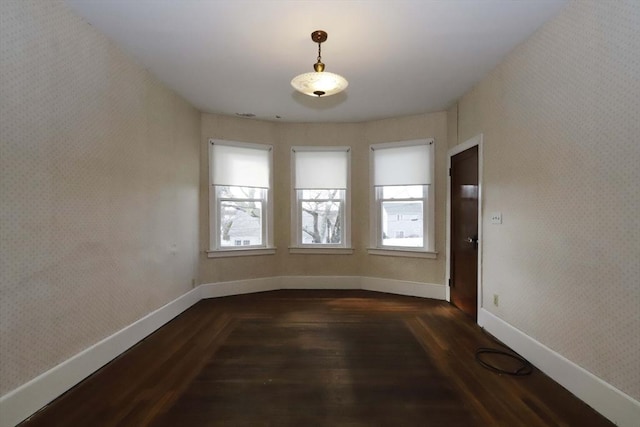 unfurnished room with dark wood-type flooring