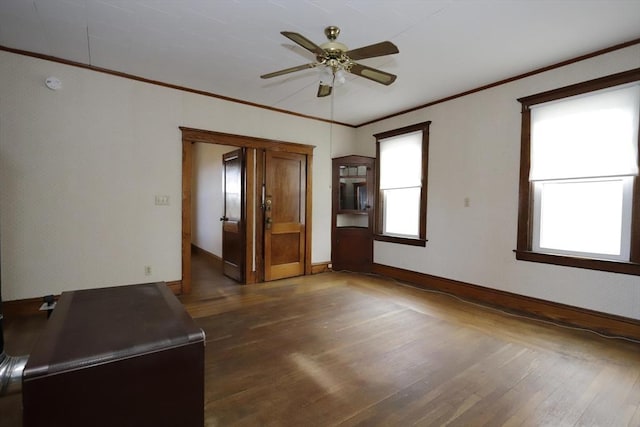 unfurnished room featuring ceiling fan, ornamental molding, and dark hardwood / wood-style flooring