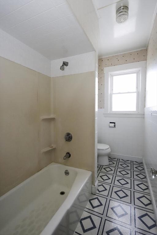 bathroom featuring washtub / shower combination and toilet