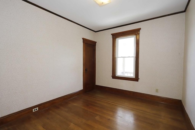 unfurnished room featuring dark wood-type flooring and ornamental molding