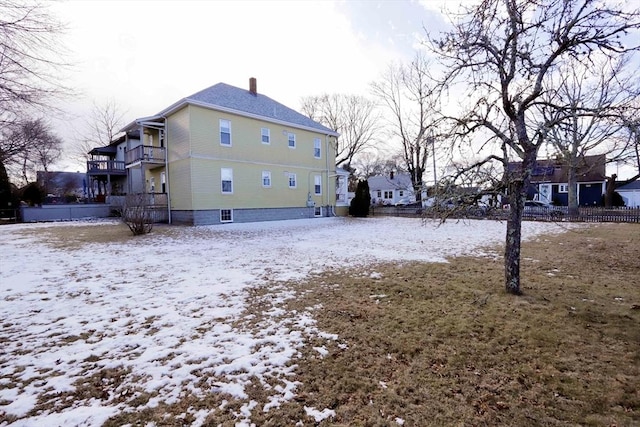 snow covered property featuring a balcony