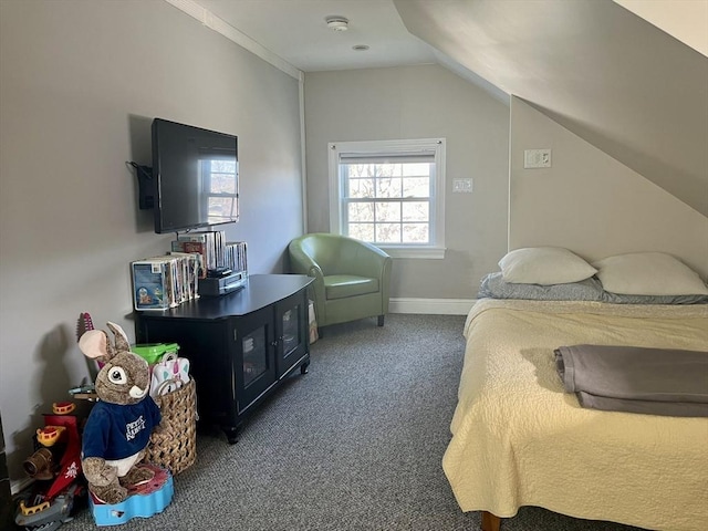 carpeted bedroom with lofted ceiling and baseboards