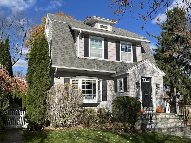 colonial inspired home featuring a shingled roof and a gambrel roof