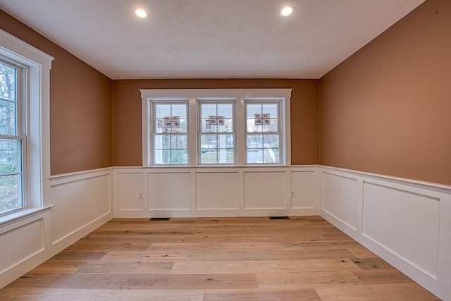 spare room with a healthy amount of sunlight and light wood-type flooring