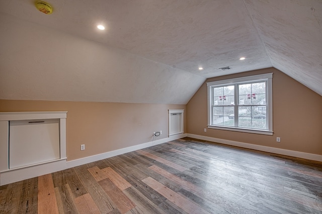 bonus room featuring lofted ceiling and hardwood / wood-style floors