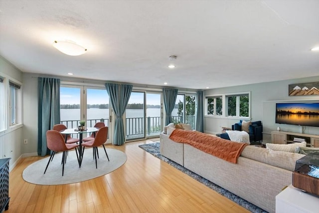living area with light wood finished floors, recessed lighting, and baseboards