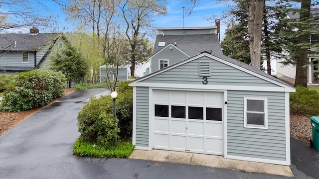 detached garage featuring driveway