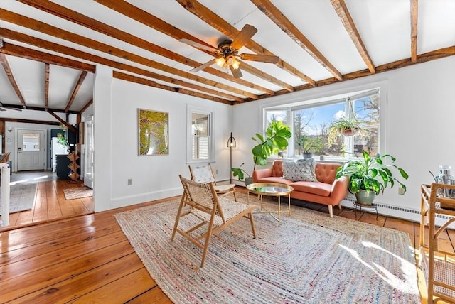 living room with beamed ceiling, baseboards, a ceiling fan, and hardwood / wood-style flooring