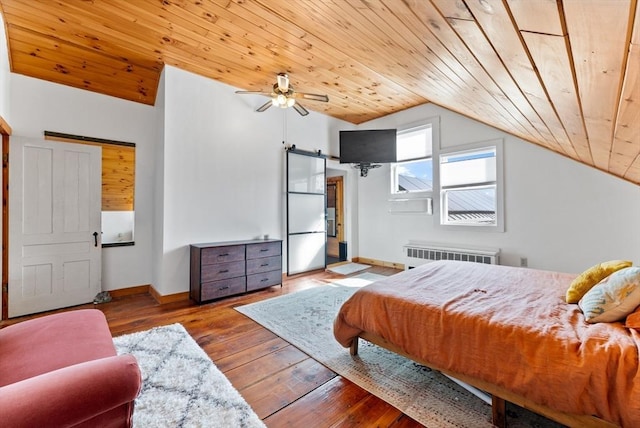 bedroom with radiator, wood ceiling, and a barn door