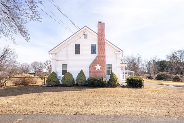 view of side of home with a chimney