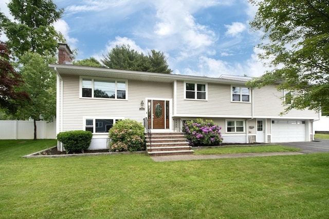 215 Alida Rd, Braintree, MA 02184 - split foyer home with a chimney, driveway, and an attached garage