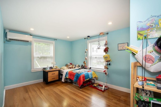 215 Alida Rd, Braintree, MA 02184 - bedroom featuring a wall unit AC, wood finished floors, and recessed lighting