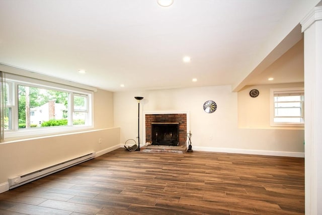 215 Alida Rd, Braintree, MA 02184 - unfurnished living room featuring a baseboard heating unit, plenty of natural light, wood finished floors, recessed lighting, and a brick fireplace
