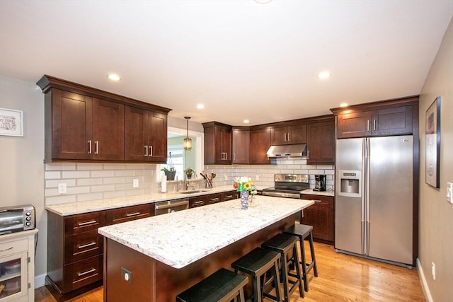 215 Alida Rd, Braintree, MA 02184 - kitchen featuring stainless steel appliances, under cabinet range hood, backsplash, light wood-type flooring, and recessed lighting