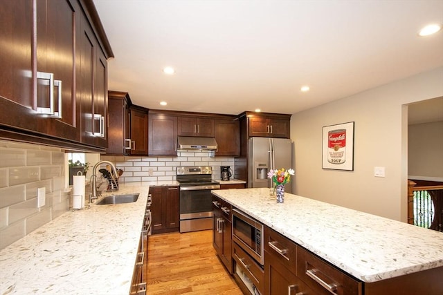 215 Alida Rd, Braintree, MA 02184 - kitchen with appliances with stainless steel finishes, under cabinet range hood, decorative backsplash, light stone countertops, and dark brown cabinets