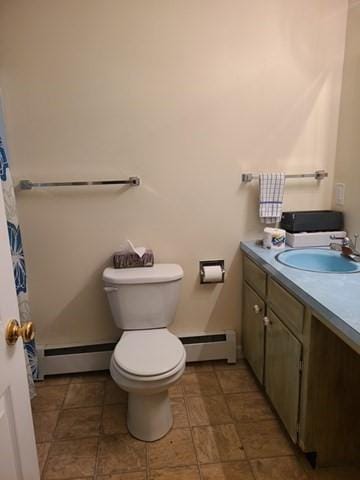 full bathroom featuring a baseboard heating unit, baseboard heating, vanity, and toilet