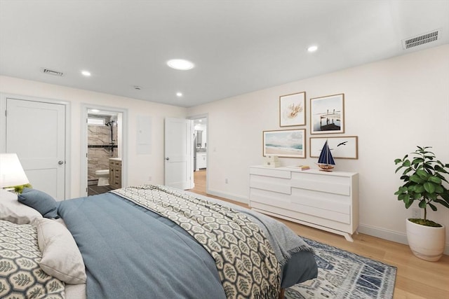bedroom featuring light wood-type flooring, baseboards, recessed lighting, and ensuite bathroom