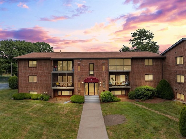 221 Oak St Unit 223, Brockton, MA 02302 - view of front of home featuring a yard and brick siding