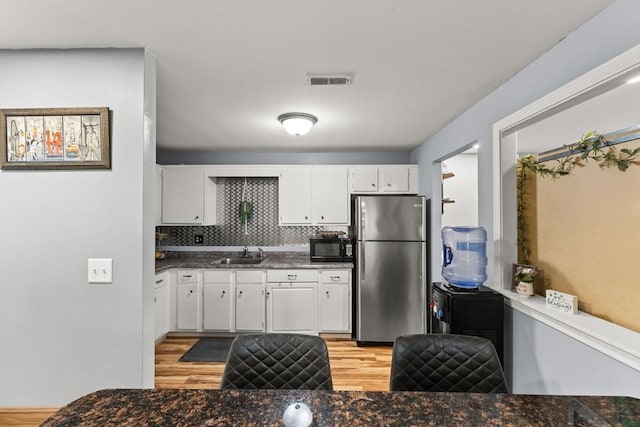 221 Oak St Unit 223, Brockton, MA 02302 - kitchen featuring freestanding refrigerator, black microwave, light wood finished floors, and white cabinetry