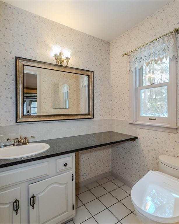 bathroom featuring toilet, wallpapered walls, tile patterned flooring, and vanity