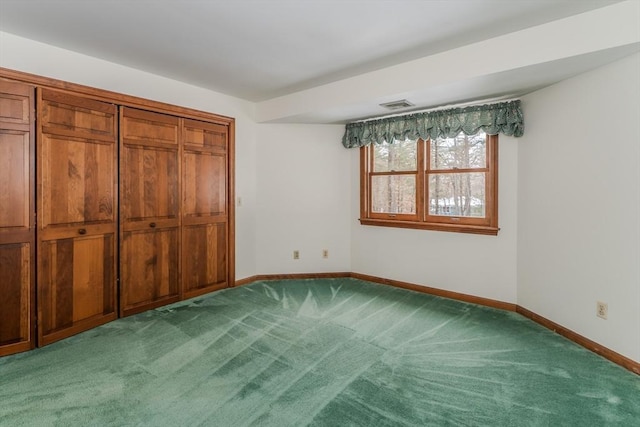 unfurnished bedroom featuring carpet floors, visible vents, and baseboards