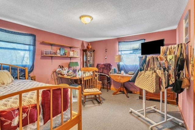 carpeted bedroom with a textured ceiling