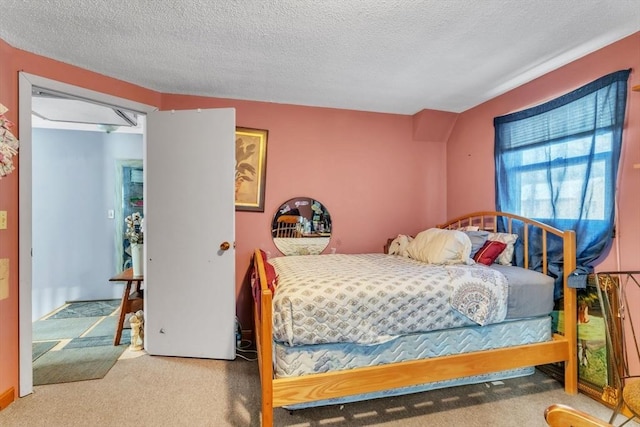 bedroom with carpet flooring and a textured ceiling