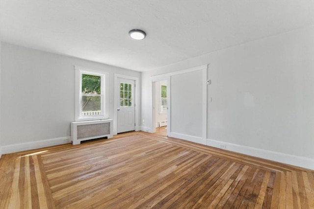 515 Front St, Weymouth, MA 02188 - empty room featuring radiator, baseboards, and hardwood / wood-style flooring