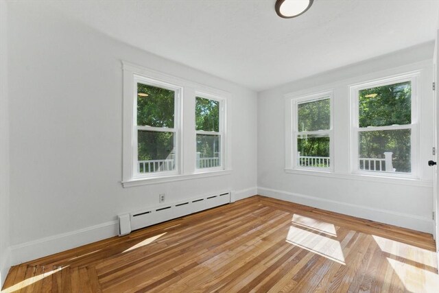 515 Front St, Weymouth, MA 02188 - spare room featuring baseboard heating, baseboards, and light wood-style floors