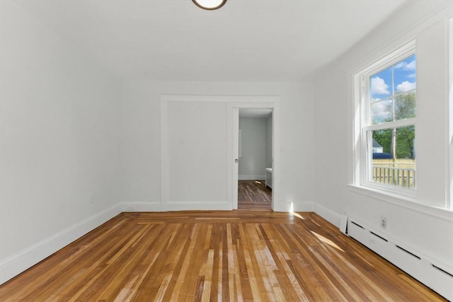 515 Front St, Weymouth, MA 02188 - unfurnished room featuring baseboard heating, light wood-style flooring, and baseboards