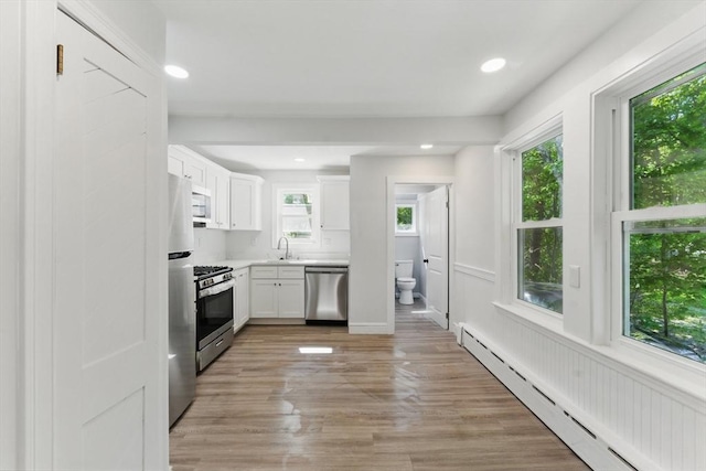 515 Front St, Weymouth, MA 02188 - kitchen featuring baseboard heating, stainless steel appliances, white cabinetry, light countertops, and recessed lighting