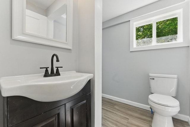 515 Front St, Weymouth, MA 02188 - bathroom featuring wood finished floors, toilet, vanity, and baseboards