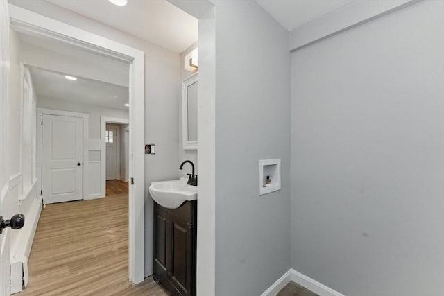 515 Front St, Weymouth, MA 02188 - bathroom with wood finished floors, vanity, and baseboards