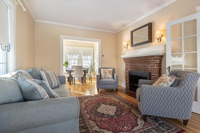 living room featuring ornamental molding, wood-type flooring, and a brick fireplace