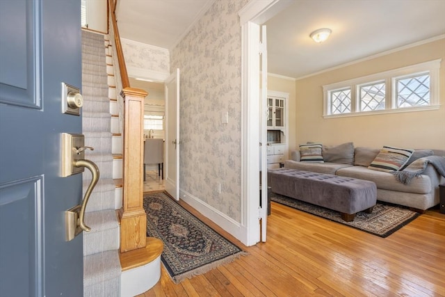 living room featuring hardwood / wood-style floors and crown molding