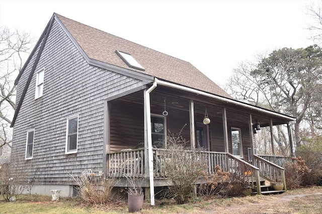 view of side of home with covered porch