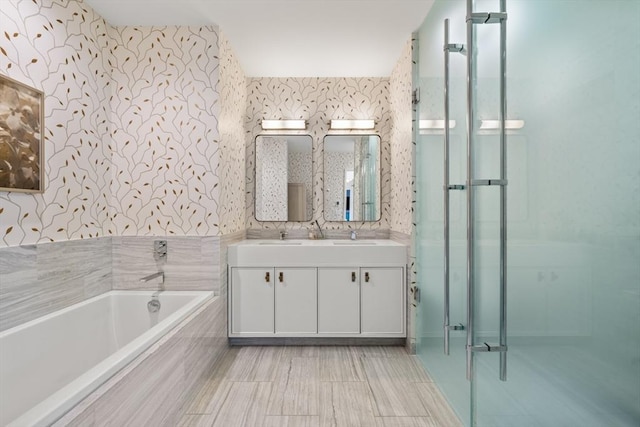 bathroom featuring shower with separate bathtub and vanity