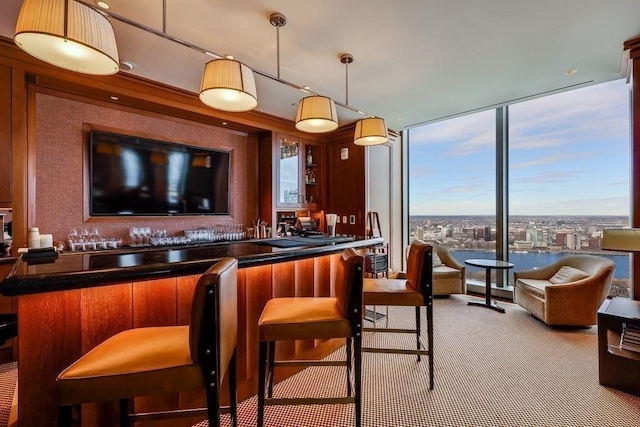 bar with hanging light fixtures, expansive windows, and light carpet