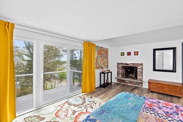 2 Cushing Lndg, Scituate, MA 02066 - living area featuring healthy amount of natural light, vaulted ceiling, wood finished floors, a brick fireplace, and baseboards