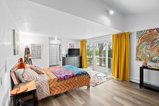 2 Cushing Lndg, Scituate, MA 02066 - bedroom with access to outside, wood finished floors, a closet, and a textured ceiling