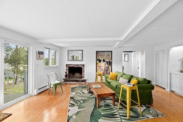 2 Cushing Lndg, Scituate, MA 02066 - living room with hardwood / wood-style flooring, a brick fireplace, beamed ceiling, and a baseboard radiator