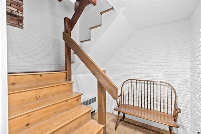 2 Cushing Lndg, Scituate, MA 02066 - stairway with brick wall, tile patterned floors, and radiator heating unit