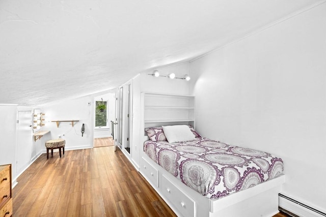 2 Cushing Lndg, Scituate, MA 02066 - bedroom featuring a baseboard heating unit, wood finished floors, and lofted ceiling