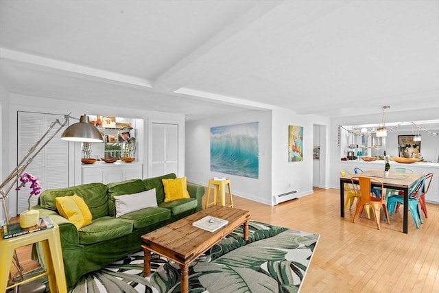 2 Cushing Lndg, Scituate, MA 02066 - living area featuring a baseboard radiator, light wood-type flooring, beam ceiling, a chandelier, and baseboards